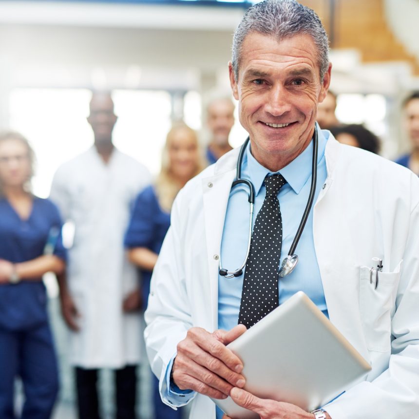 Adult man in doc uniform with tablet